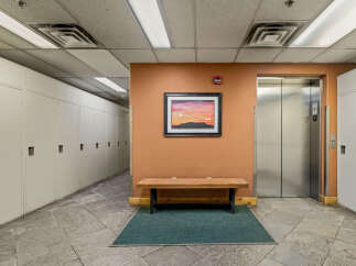 This image showcases a well-maintained hallway featuring rows of white lockers, perfect for storage or personal belongings.