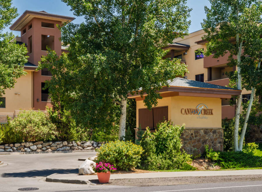 Discover Canyon Creek at Eagle Lodge, a premier real estate offering nestled amidst lush greenery and mature trees.