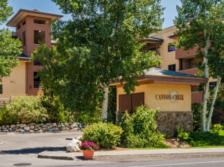 Discover Canyon Creek at Eagle Lodge, a premier real estate offering nestled amidst lush greenery and mature trees.