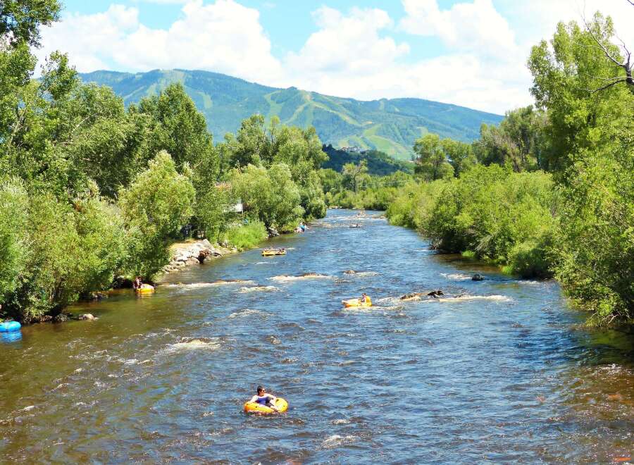 Experience the ultimate outdoor lifestyle with this stunning property offering direct access to a pristine river, perfect for summer tubing adventures.