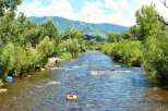 Experience the ultimate outdoor lifestyle with this stunning property offering direct access to a pristine river, perfect for summer tubing adventures.