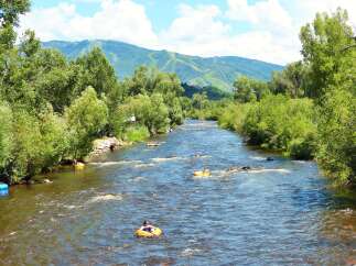 Experience the ultimate outdoor lifestyle with this stunning property offering direct access to a pristine river, perfect for summer tubing adventures.