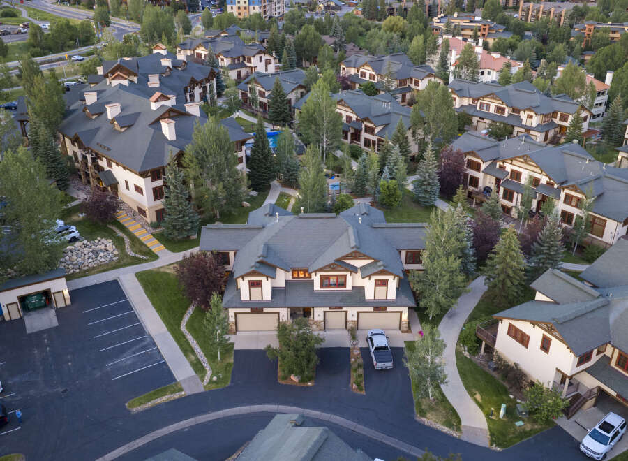 Experience luxury mountain living in this stunning multi-unit property, nestled amidst lush greenery and mature trees.