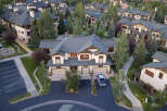 Experience luxury mountain living in this stunning multi-unit property, featuring a classic alpine architectural style with dark pitched roofs and warm wood accents.