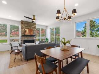Experience breathtaking mountain views from this stunning modern living and dining area.