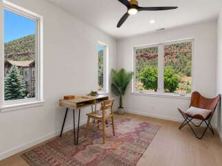 This bright and airy home office features a modern desk and chair, perfect for remote work or study.
