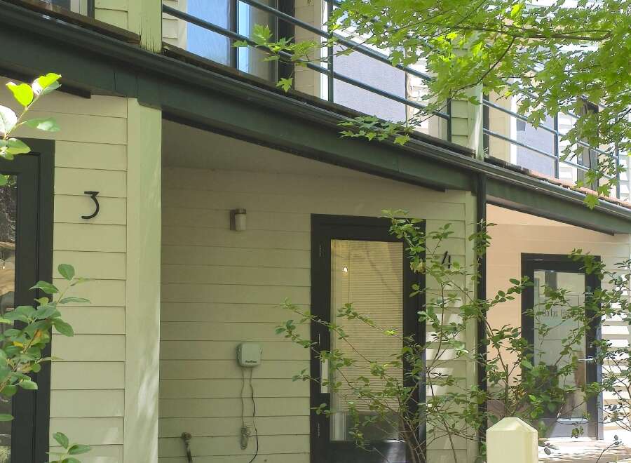Discover this charming property featuring a welcoming facade with a prominent number '3' and a second unit marked with '4'.