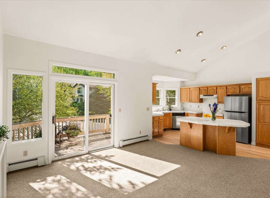 Step into this bright and airy living space, featuring a seamless flow into a well-appointed kitchen.
