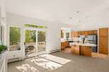 Step into this bright and airy living space, featuring a seamless flow into a well-appointed kitchen.