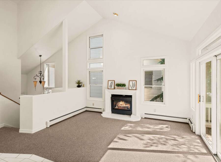 Experience the warmth of this inviting living space, featuring a cozy fireplace as the focal point.