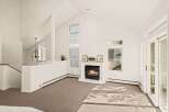 Experience the warmth of this inviting living space, featuring a cozy fireplace as the focal point.