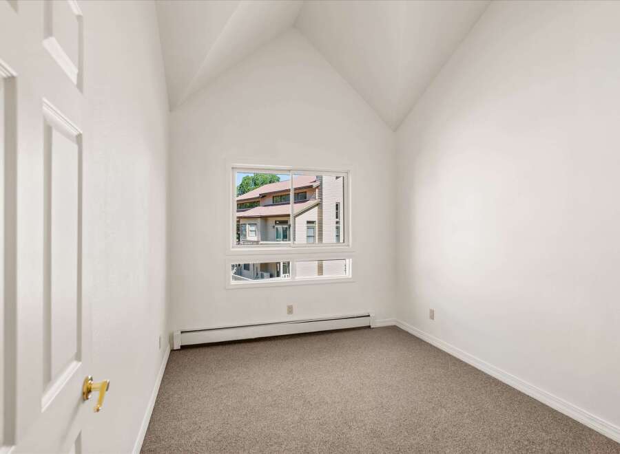 Discover this charming room featuring a vaulted ceiling that adds a sense of spaciousness and architectural interest.