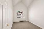 Discover this charming room featuring a vaulted ceiling that adds a sense of spaciousness and architectural interest.