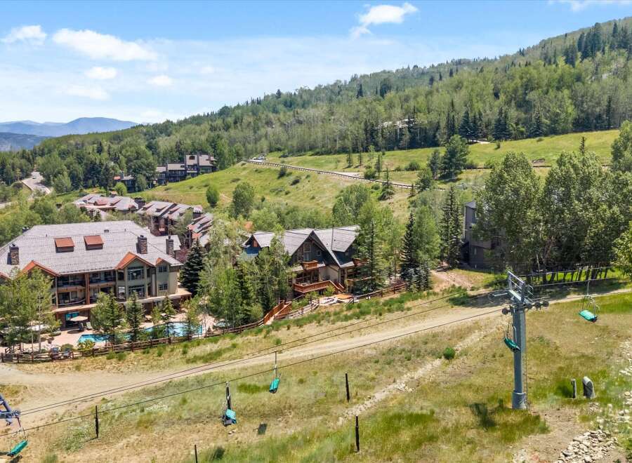 Experience luxury mountain living with this stunning property featuring a private swimming pool and hot tub, perfect for relaxation and entertaining.