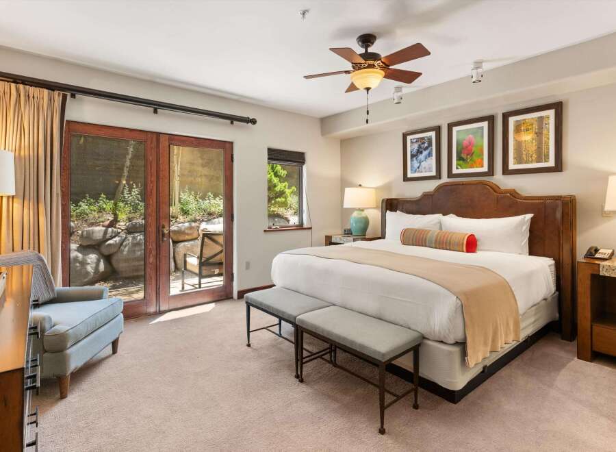 Experience luxurious comfort in this spacious bedroom, featuring a king-size bed with a plush headboard and elegant decorative pillows.