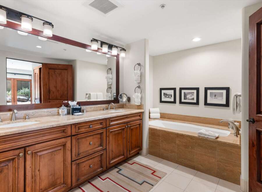 Indulge in luxury in this spacious bathroom featuring a deep soaking tub, perfect for unwinding after a long day.