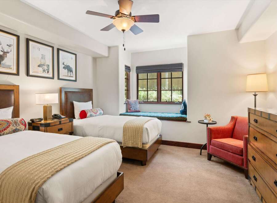 Experience comfort and style in this inviting hotel room featuring two twin beds, perfect for families or friends traveling together.