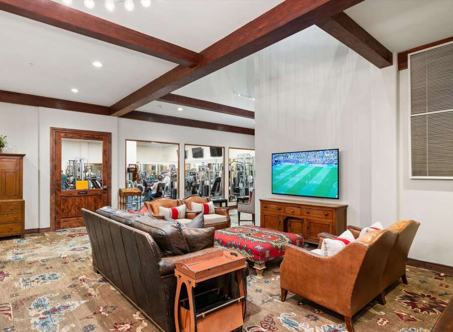 Experience ultimate relaxation and entertainment in this inviting living space, featuring a large leather sofa and comfortable armchairs perfect for unwinding.