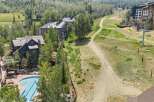 Experience luxury mountain living with this stunning property featuring a resort-style swimming pool and hot tub, perfect for relaxation after a day of adventure.