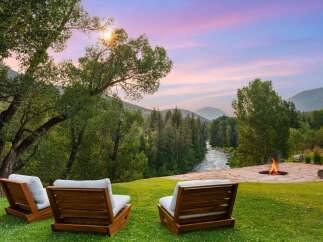 Experience breathtaking sunset views over a serene river valley from this stunning property.