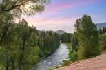 Experience the serene beauty of this mountain retreat, featuring a picturesque river flowing through lush greenery.