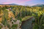 Experience luxury living with this stunning modern home nestled beside a serene river.