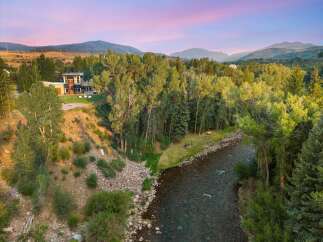Experience luxury living with this stunning modern home nestled beside a serene river.