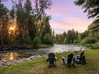 Experience serene living with this stunning property featuring a tranquil riverfront setting.