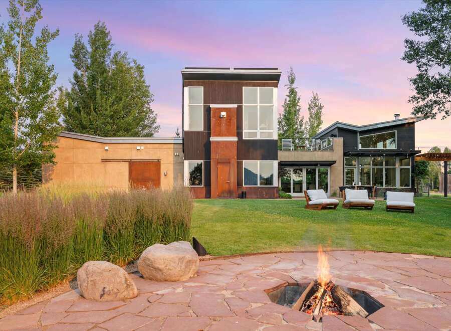 Experience modern living with this stunning property featuring a unique architectural design and expansive windows that capture breathtaking sunset views.
