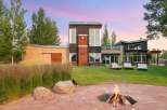 Experience modern living with this stunning property featuring a unique architectural design and expansive windows that capture breathtaking sunset views.