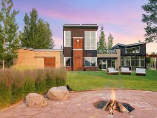 Experience modern living with this stunning property featuring a unique architectural design and expansive windows that capture breathtaking sunset views.