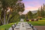 Experience luxurious outdoor dining with a stunning mountain backdrop and a serene river view.