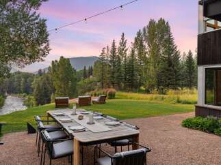 Experience breathtaking mountain views from this stunning outdoor dining area, perfect for al fresco entertaining.