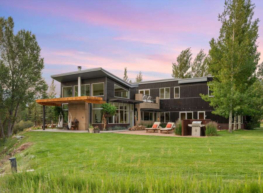 Experience modern luxury in this stunning contemporary home, featuring expansive windows that capture breathtaking sunset views.