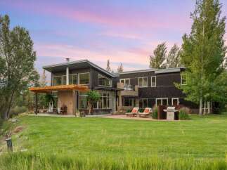 Experience modern luxury in this stunning contemporary home, featuring expansive windows that capture breathtaking sunset views.
