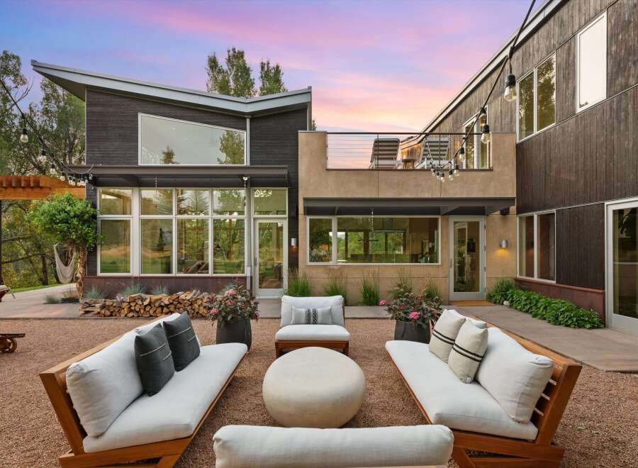 Experience modern luxury in this stunning home featuring a spacious outdoor living area perfect for entertaining.