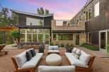 Experience modern luxury in this stunning home featuring a spacious outdoor living area perfect for entertaining.