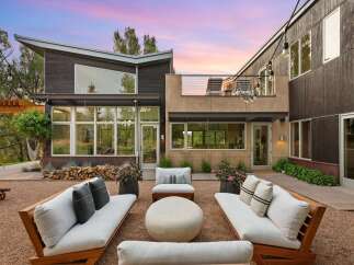 Experience modern luxury in this stunning home featuring a spacious outdoor living area perfect for entertaining.