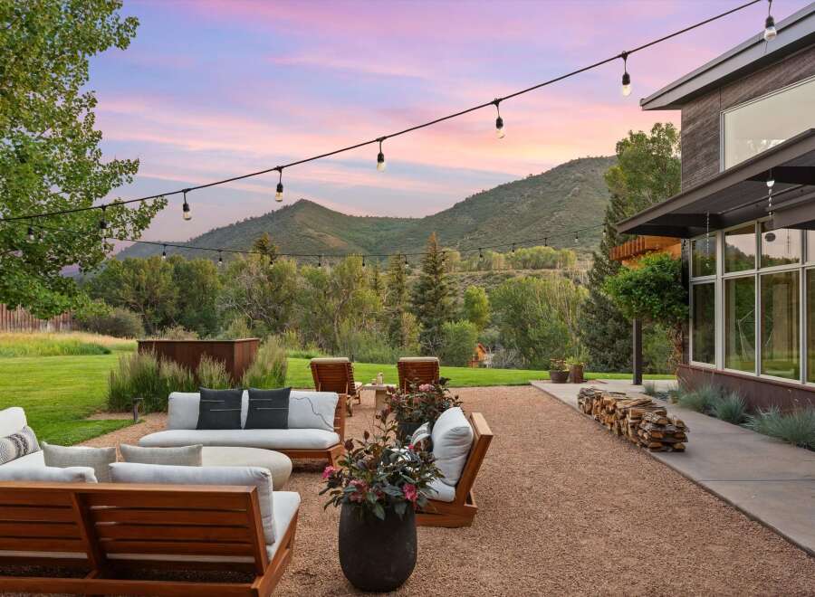 Experience breathtaking mountain views from this stunning outdoor living space, perfect for entertaining or relaxing.