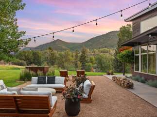Experience breathtaking mountain views from this stunning outdoor living space, perfect for entertaining or relaxing.