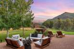 Experience serene outdoor living with this inviting patio space, featuring comfortable seating and lounge chairs perfect for relaxation.
