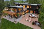 Experience modern luxury in this stunning contemporary home, featuring sleek dark wood siding and expansive windows that invite natural light.