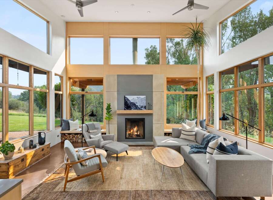 Experience modern living in this stunning great room, bathed in natural light from expansive windows.