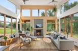 Experience modern living in this stunning great room, bathed in natural light from expansive windows.