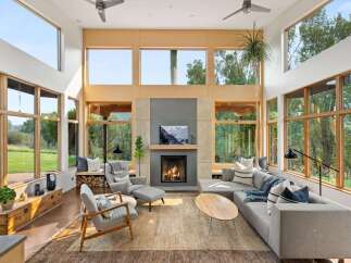 Experience modern living in this stunning great room, bathed in natural light from expansive windows.