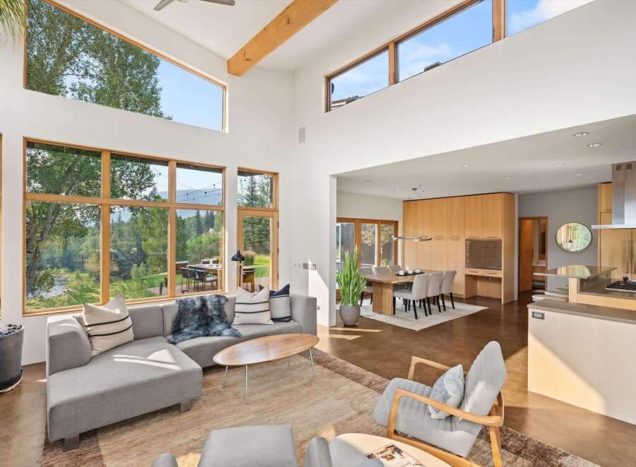 Experience modern living in this spacious open-concept home, featuring soaring ceilings and expansive windows that flood the space with natural light.