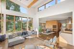 Experience modern living in this spacious open-concept home, featuring soaring ceilings and expansive windows that flood the space with natural light.