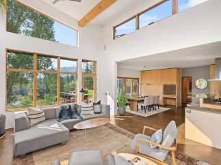 Experience modern living in this spacious open-concept home, featuring soaring ceilings and expansive windows that flood the space with natural light.