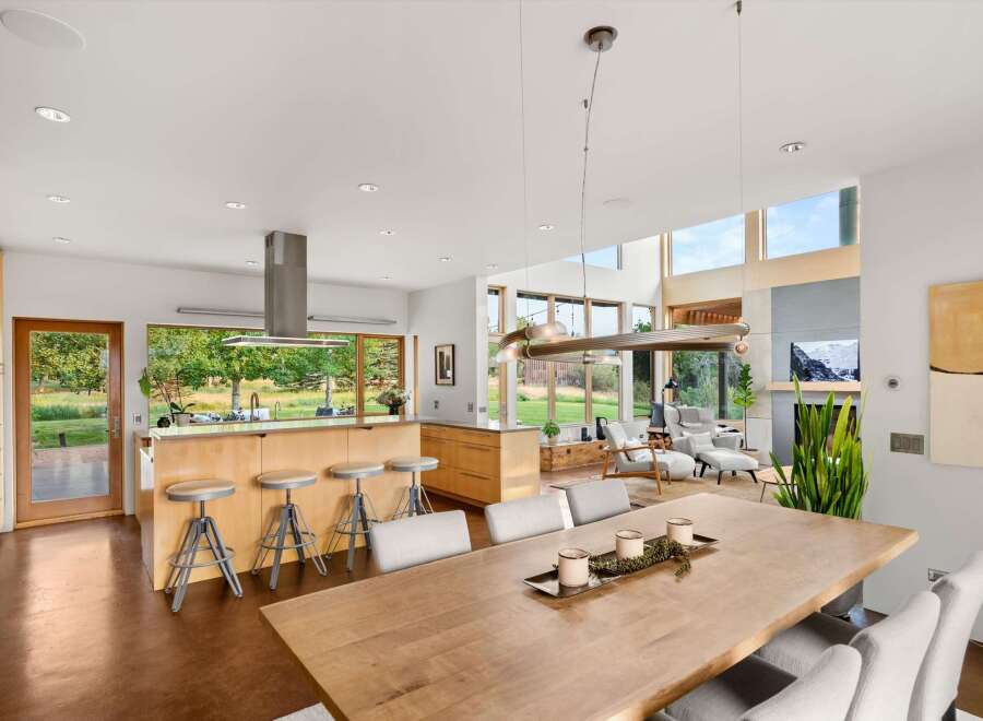 Experience modern living in this stunning open-concept home, featuring a gourmet kitchen with a large island and ample seating, perfect for entertaining.