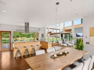 Experience modern living in this stunning open-concept home, featuring a gourmet kitchen with a large island and ample seating, perfect for entertaining.